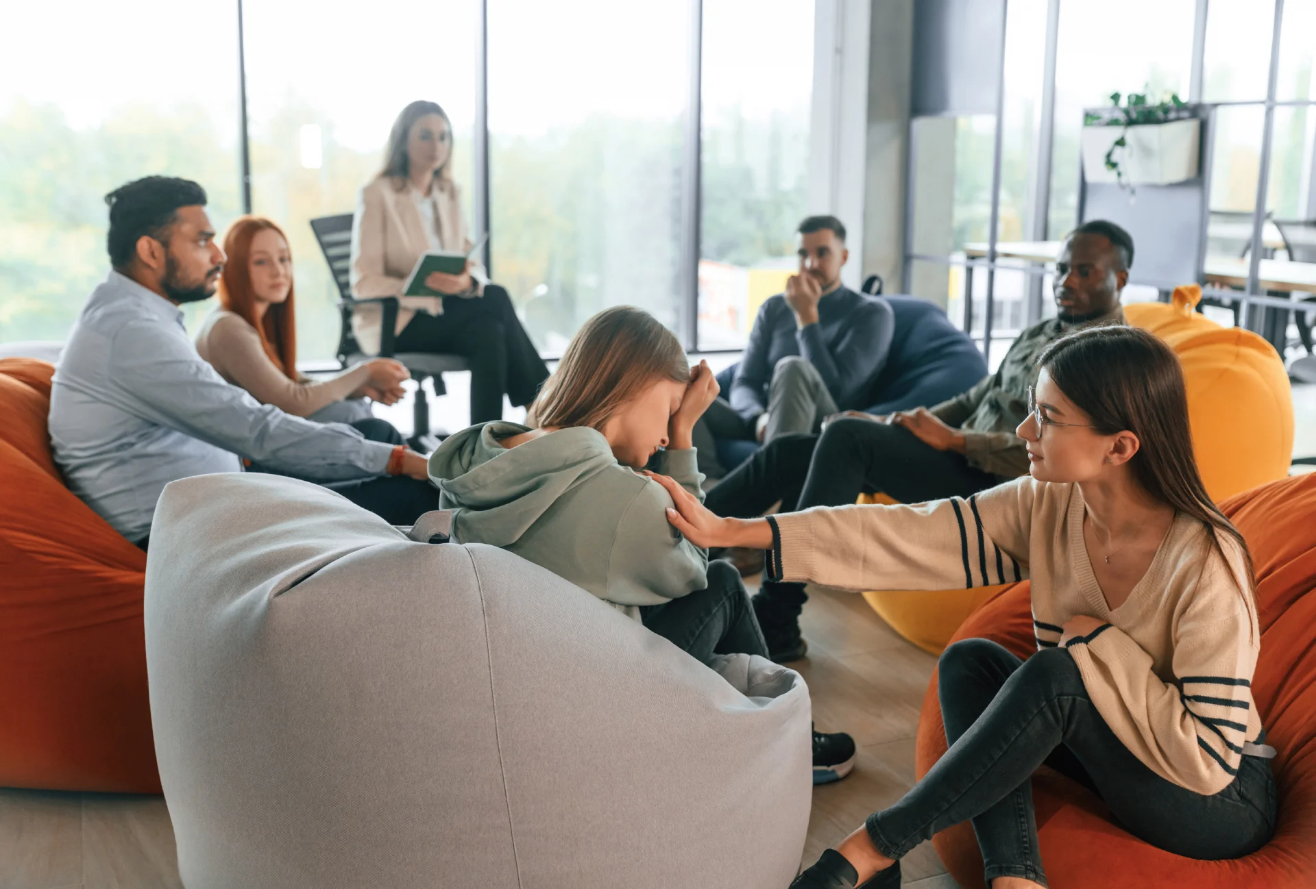 Group therapy session at Hudson Valley Addiction Treatment Center, individuals discussing MDMA addiction, emotional support, and recovery, with a focus on therapeutic engagement and mental health.