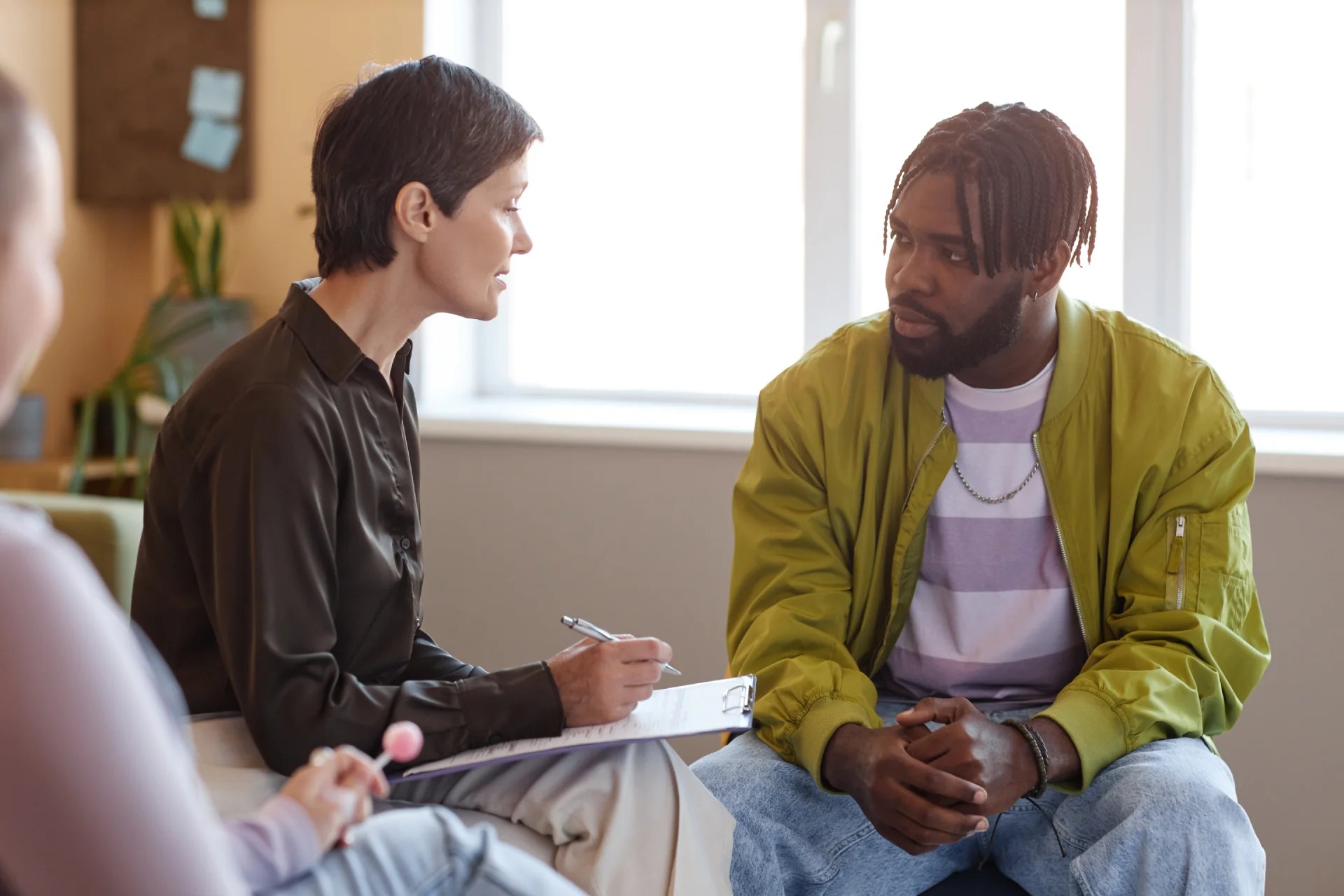 Therapist engaging in individual counseling session with client in outpatient rehab setting, emphasizing emotional support and recovery strategies.